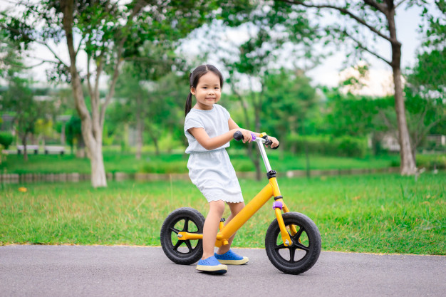 little girl riding balance bike park 53945 524